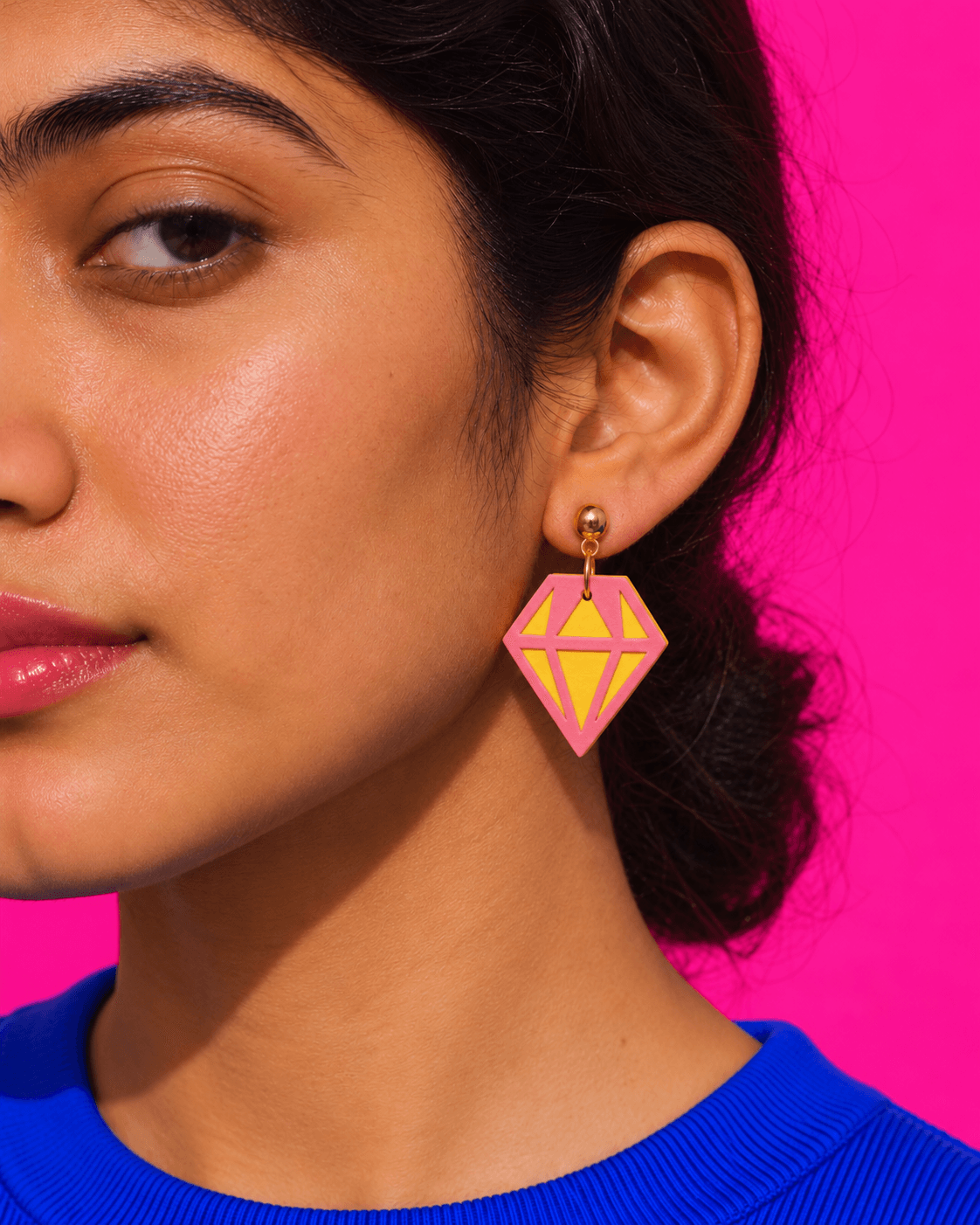 Close view of the layered pink and yellow Faceted Gem worn on a gold looped ball post.