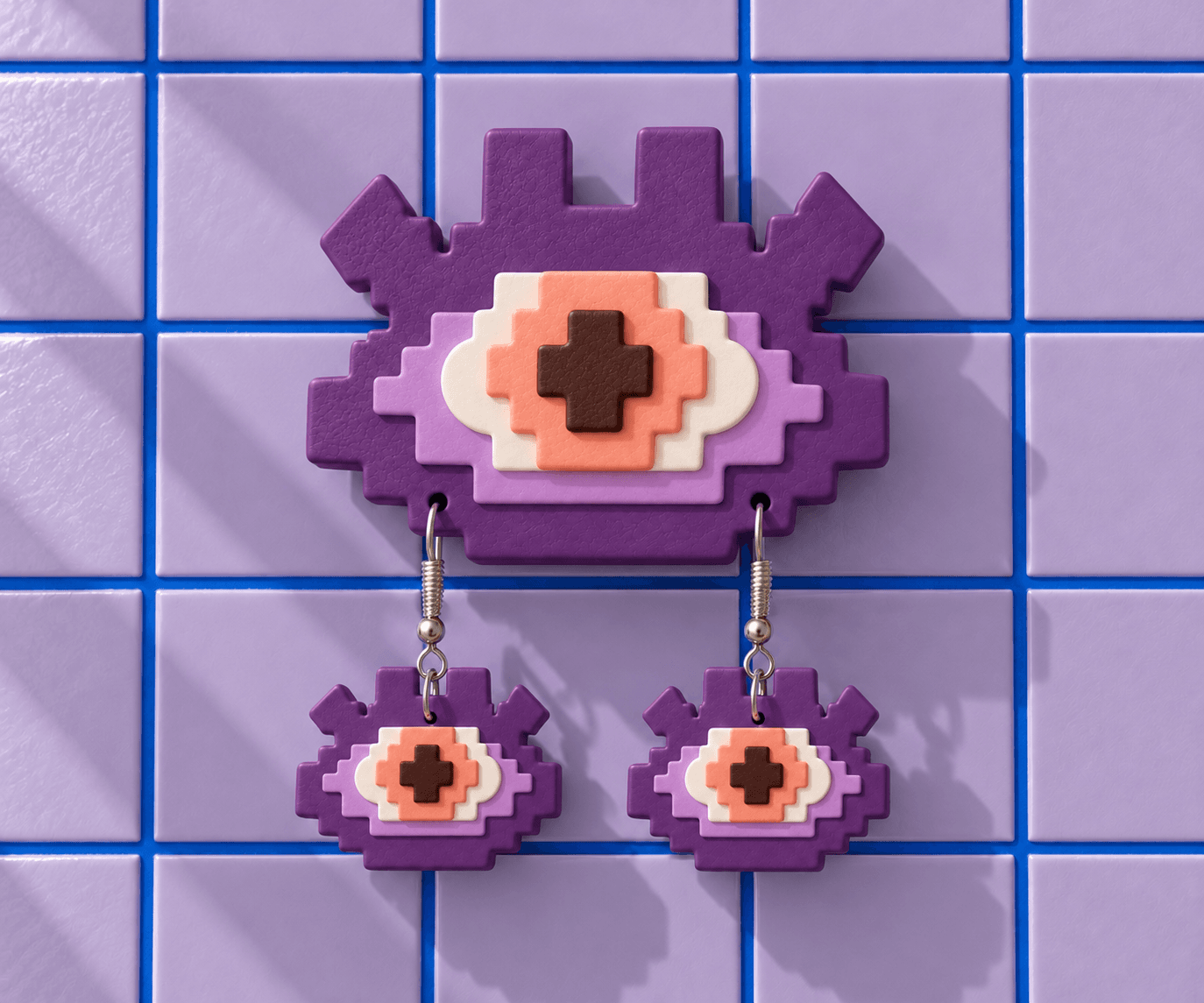 Violet Pixel Eye wall display with lavender and white layers, a peach iris and matching drop earrings against lavender tiles.