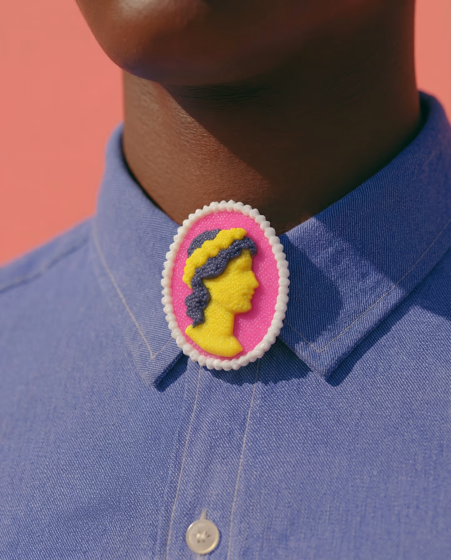 Pink Cameo Profile Brooch in styled context. Build this as a flat oval plaque with raised profile and hair pieces, not as a full 3D bust. The image pair shows a hot-pink cameo bas…