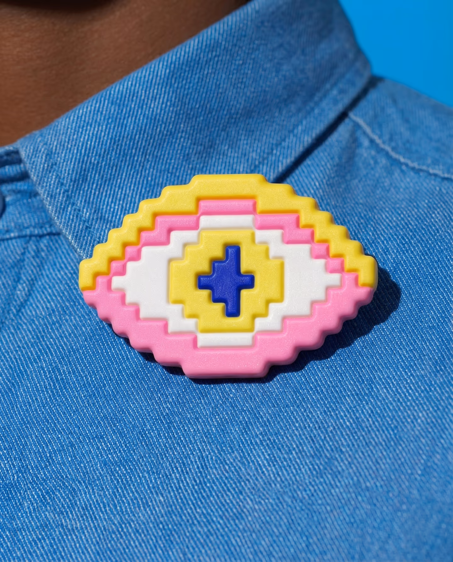 Yellow and Pink Flat Pixel Eyeball Brooch in styled context. Build this as a flat oval eye plaque with stepped concentric bands, not as the rounded dome used on the other eyeball…
