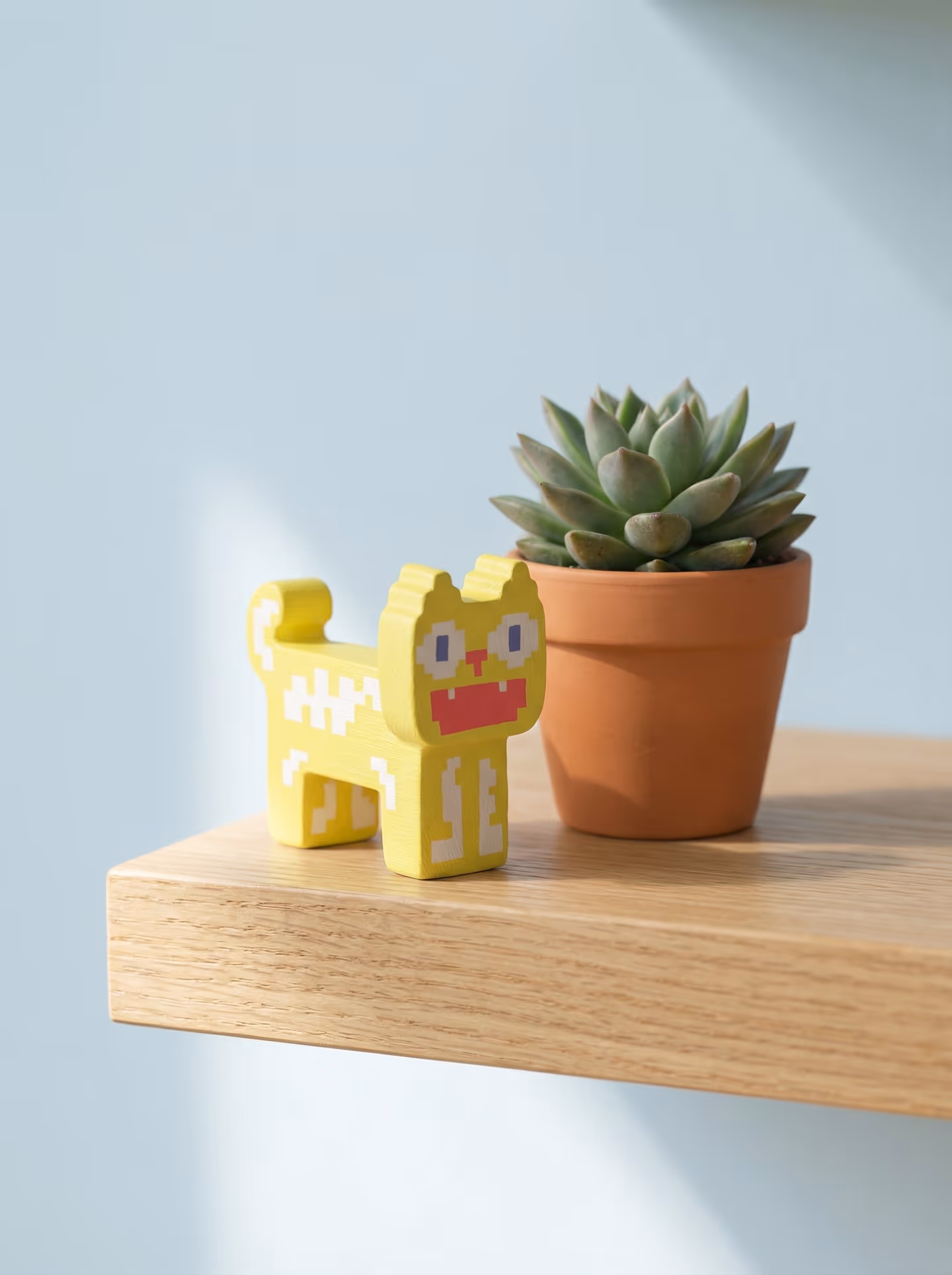 Yellow Minimal Pixel Cat Figurine in styled context. Start with one thick pixel-cat silhouette, because the image pair shows a flat-sided standing body with a curled tail and step…