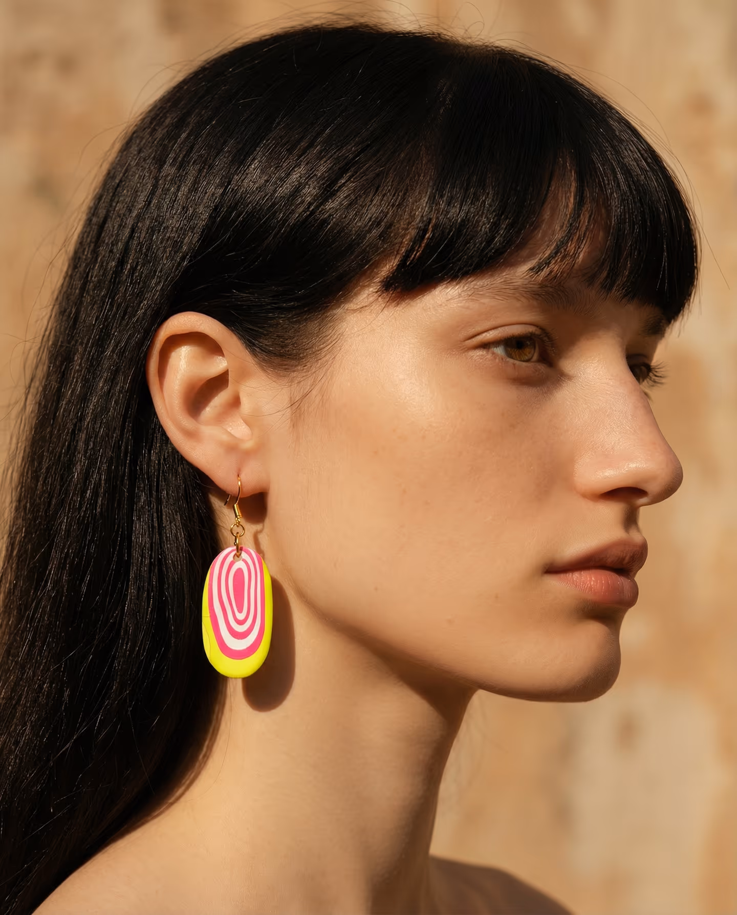 Neon Bullseye Oval Drop Earrings in styled context. Start with a pink-and-white bullseye cane and a chartreuse oval base, because the image pair shows crisp concentric rings cente…