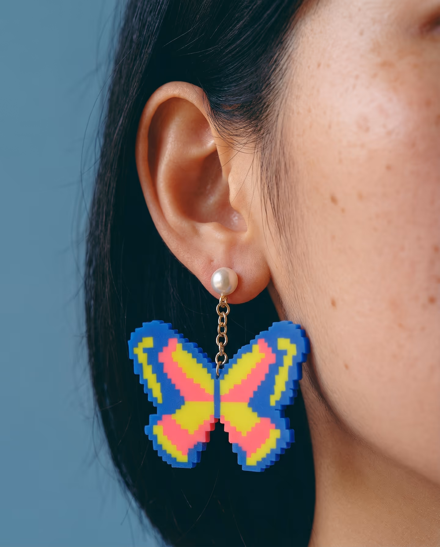 Blue, Yellow, and Pink Pixel Butterfly Pearl Drop Earrings in styled context. Start with one cobalt-blue butterfly blank and cut it twice from the same template, because both imag…