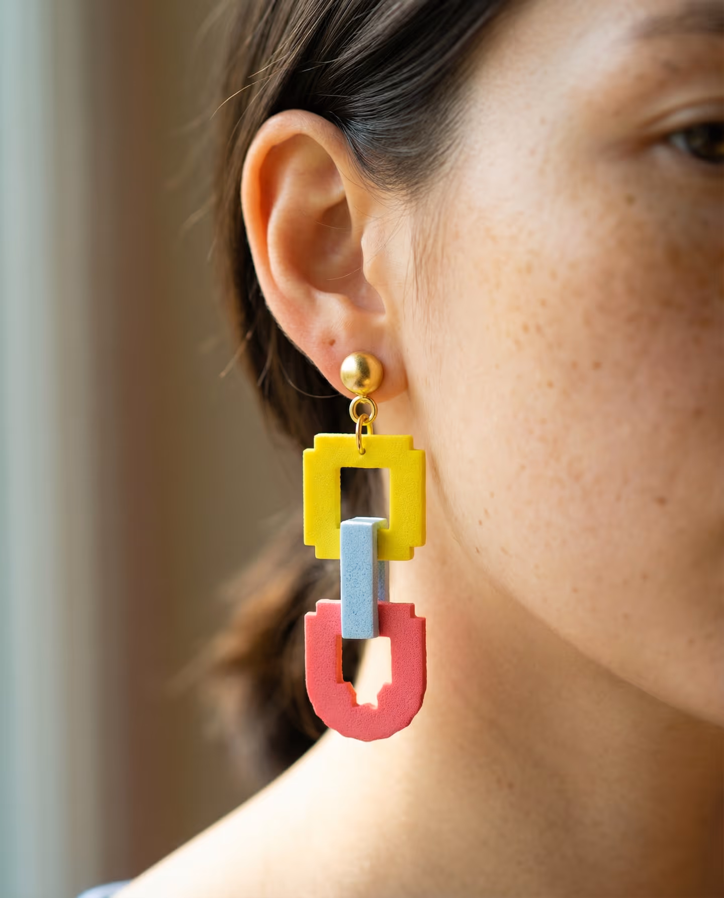 Pixel Chain Link Drop Earrings in styled context. Start with three separate open slab links, because both images show the yellow, pale-blue, and coral-pink parts assembled after c…