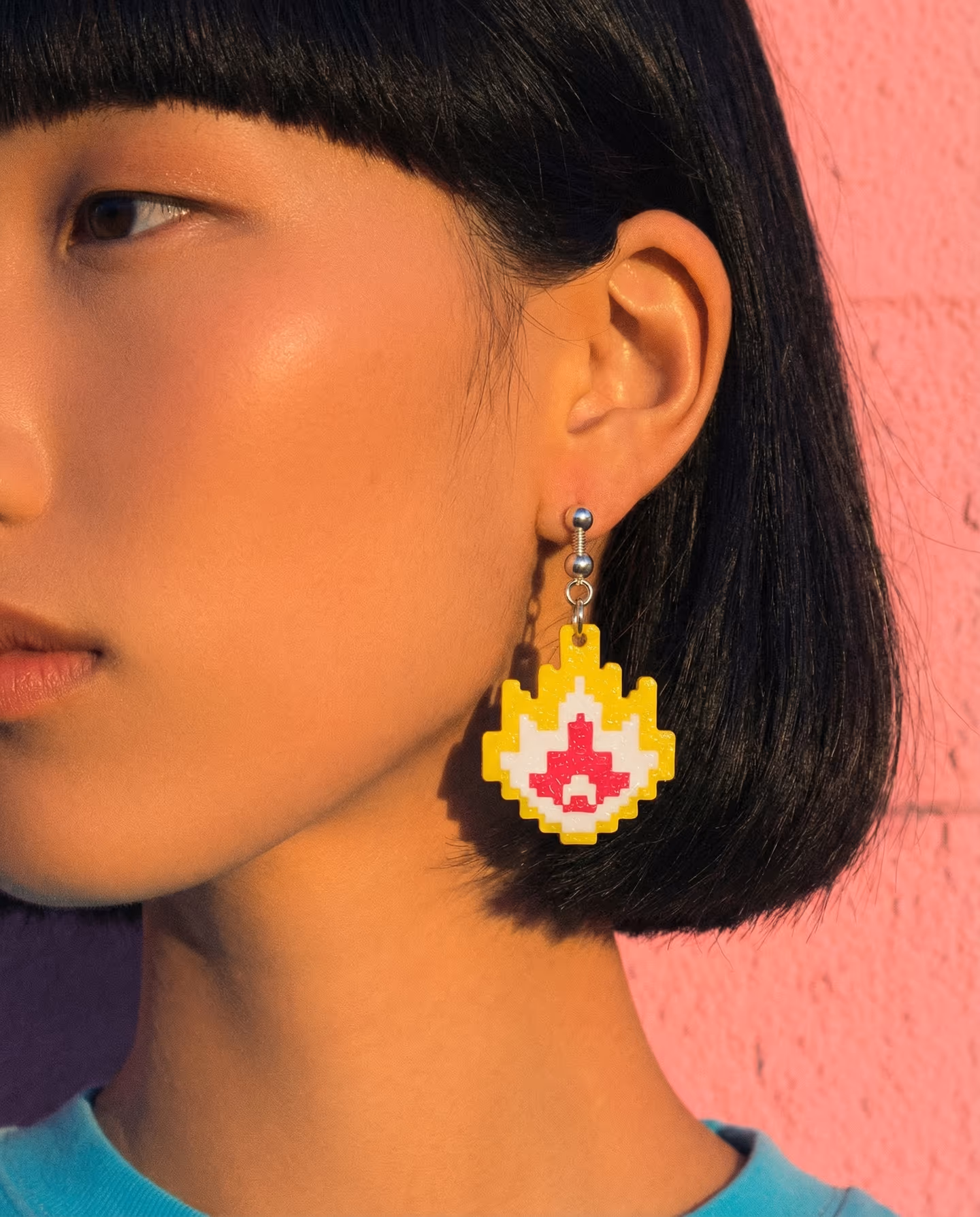 Yellow Pixel Flame Earrings in styled context. Build these as flat three-layer pixel-stepped flame drops. The image pair shows a yellow glitter polymer clay outer flame silhouette…