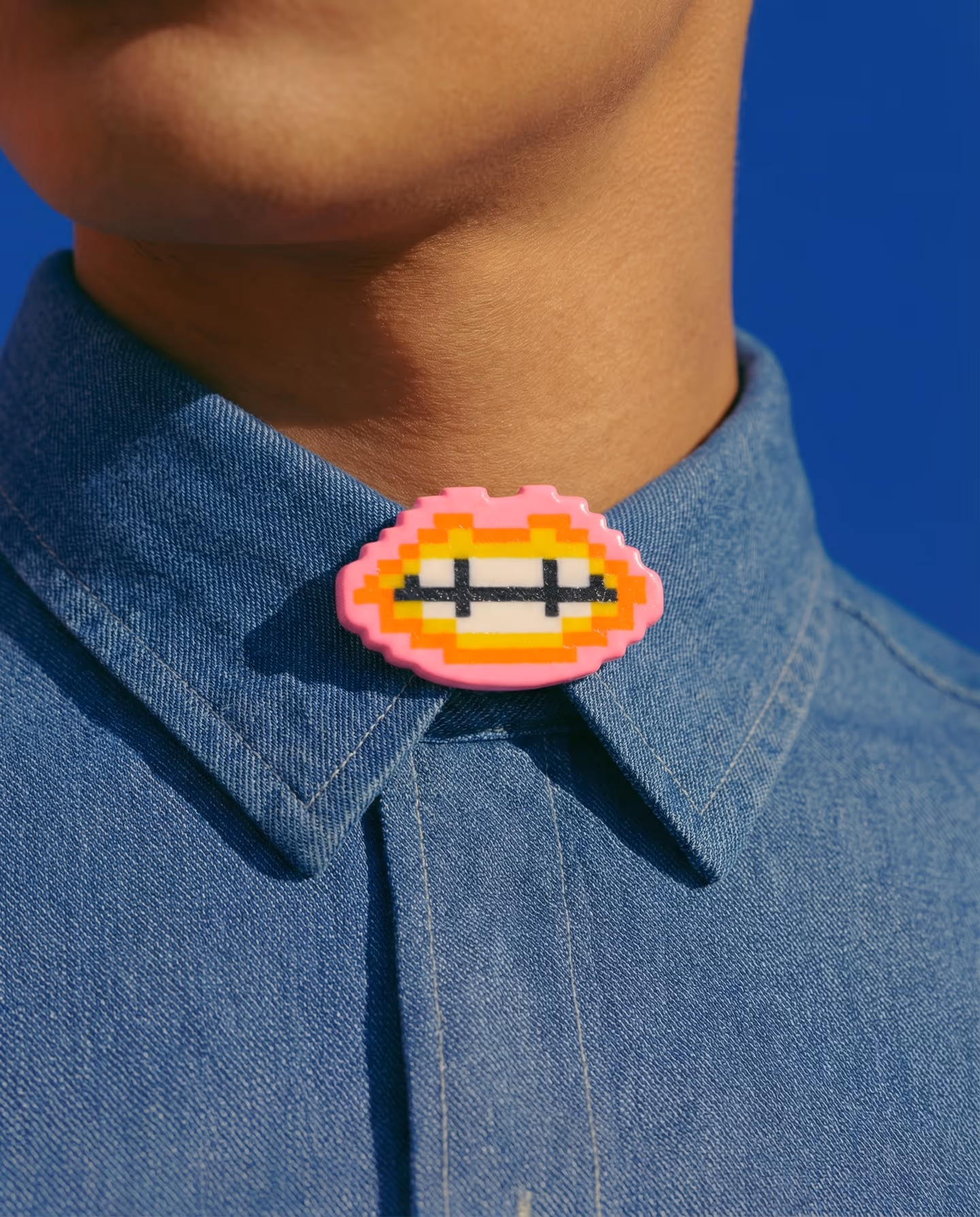 Pink Orange and Yellow Pixel Lips Brooch in styled context. Build this as a flat stepped lips badge, not as a sculpted mouth. The product image shows nested pink, orange, yellow,…