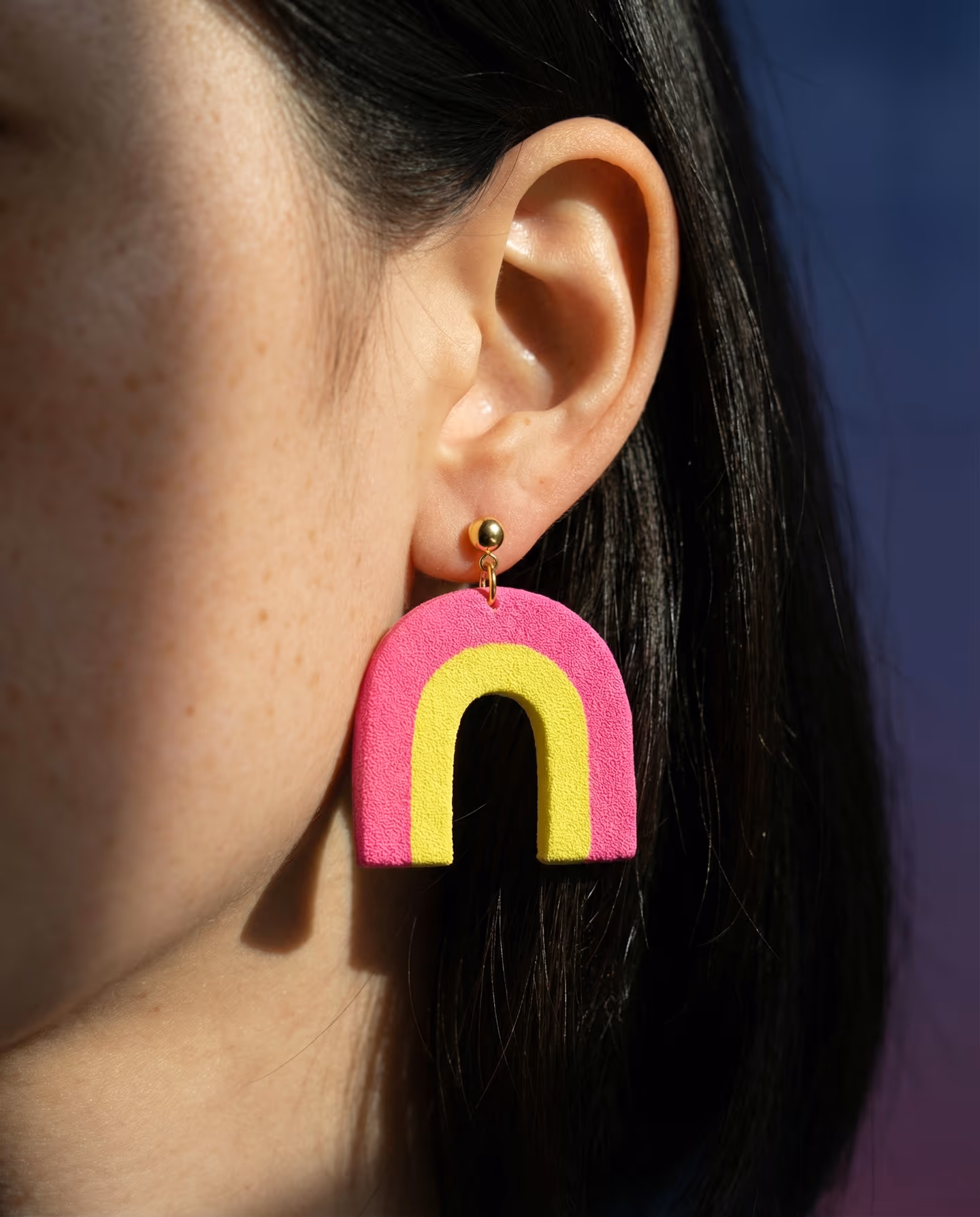 Hot Pink and Yellow Nested Arch Earrings in styled context. Start with a flat yellow arch slab and a wider hot-pink arch frame, because the image pair shows a nested two-color cut…
