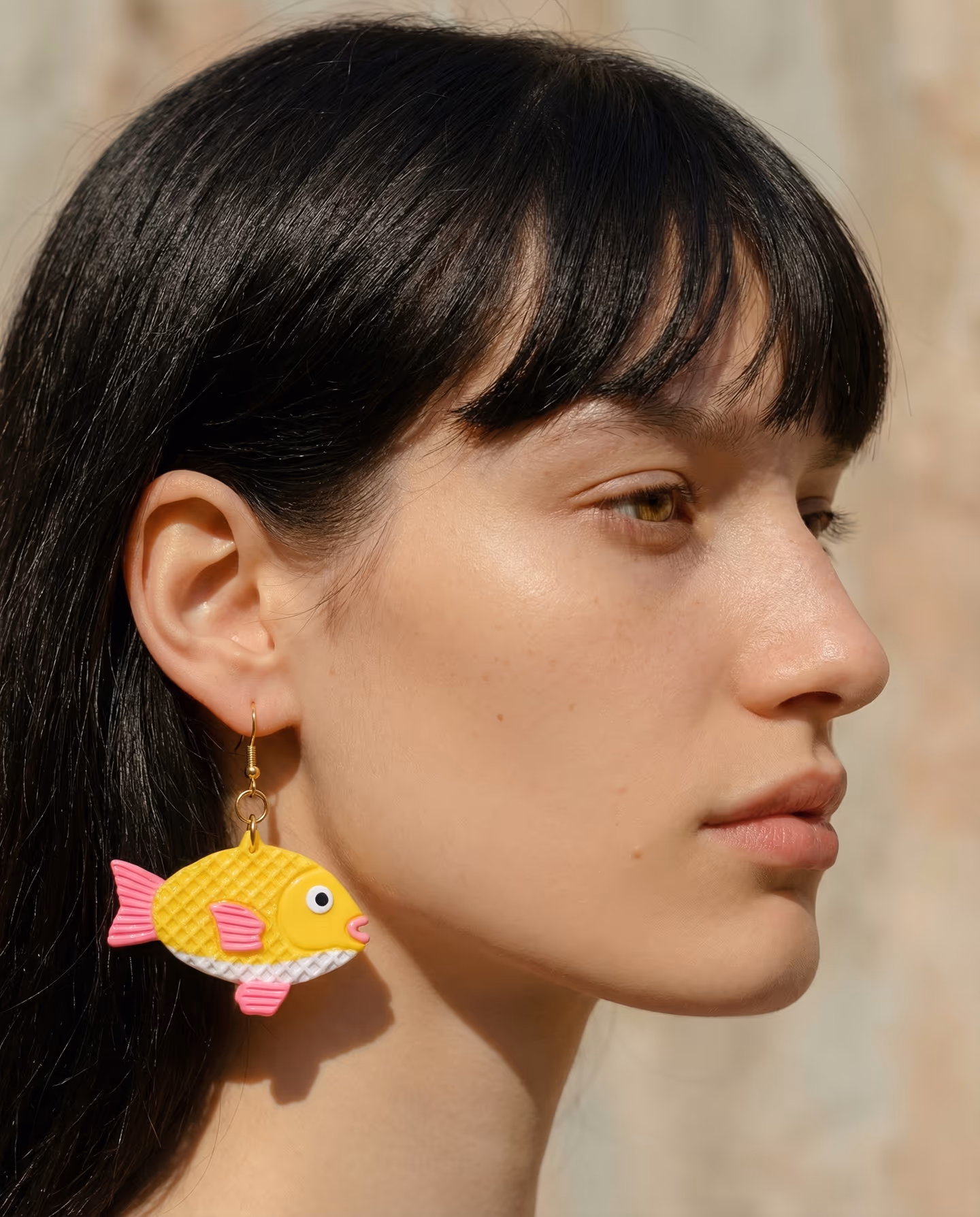 Taiyaki Fish Drop Earrings in styled context. Build these as flat taiyaki fish charms with layered fins and scored waffle texture, not as round sculpted fish bodies. The image pai…