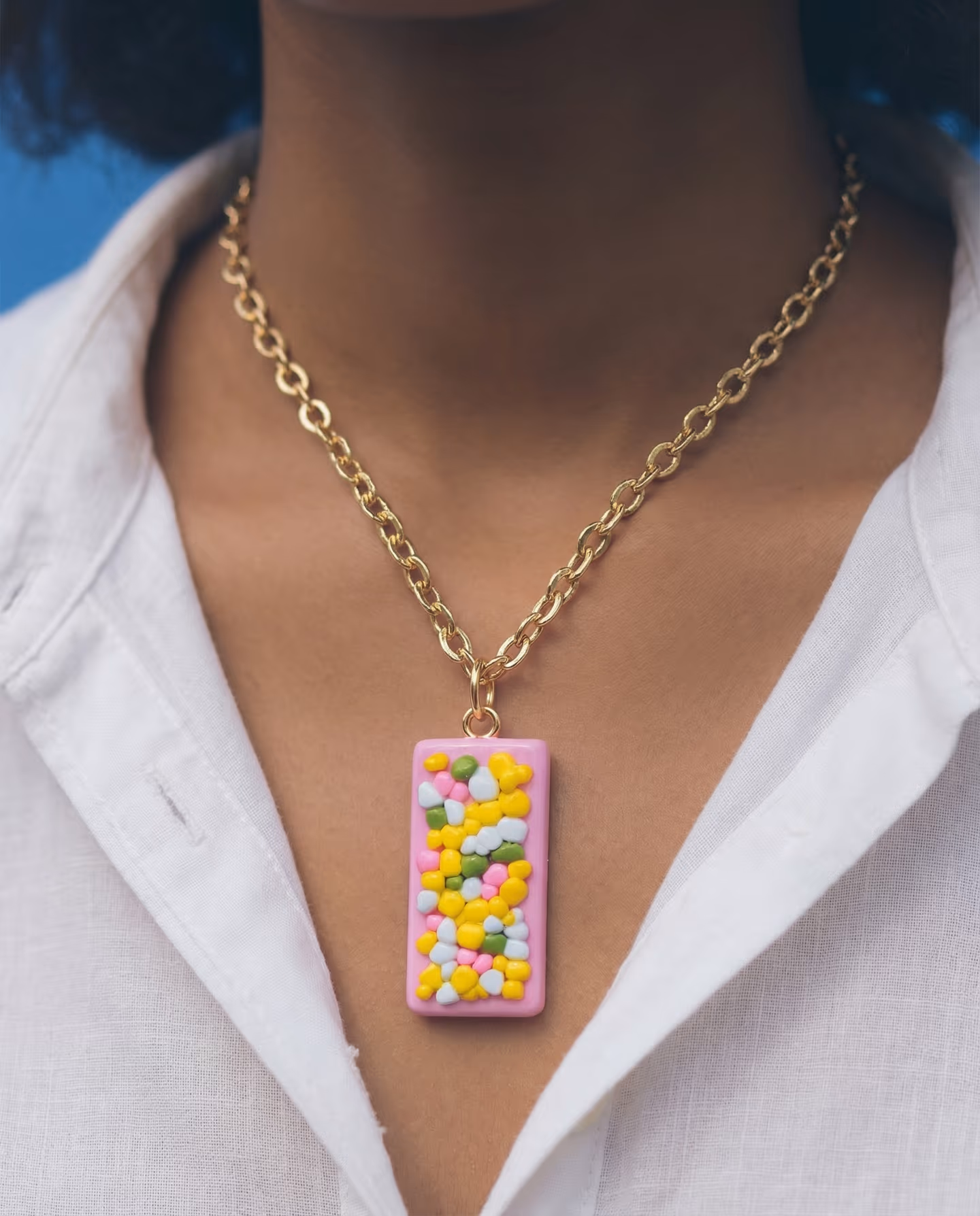 Pink Confetti Slab Pendant in styled context. Build a clean pink slab first, then press in rounded confetti pieces before you cut the rectangle and plan the gold hanging point. Th…